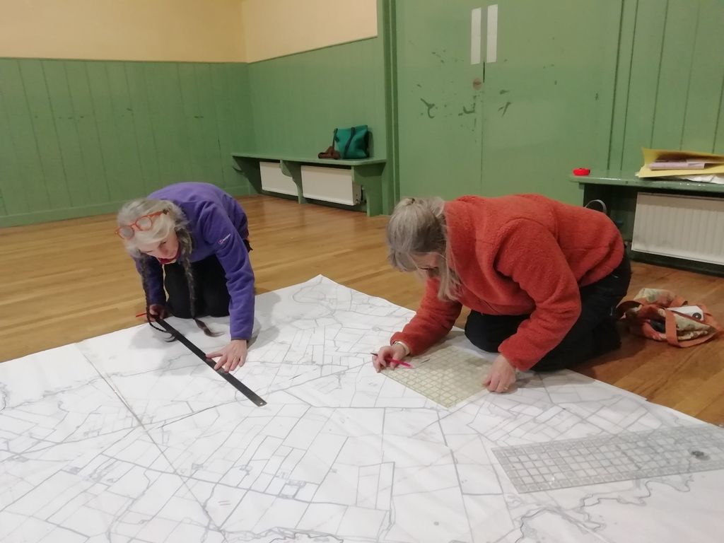 Community members working with a large map on the floor